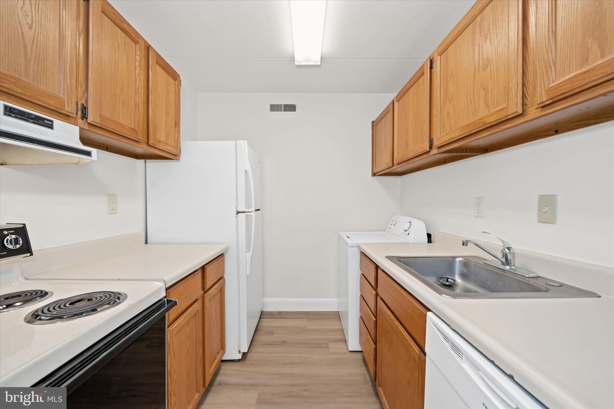 1 Berwyn Hall Dover, DE 19904 - Photo 11 of 16 a kitchen with stainless steel appliances granite countertop a sink stove and refrigerator