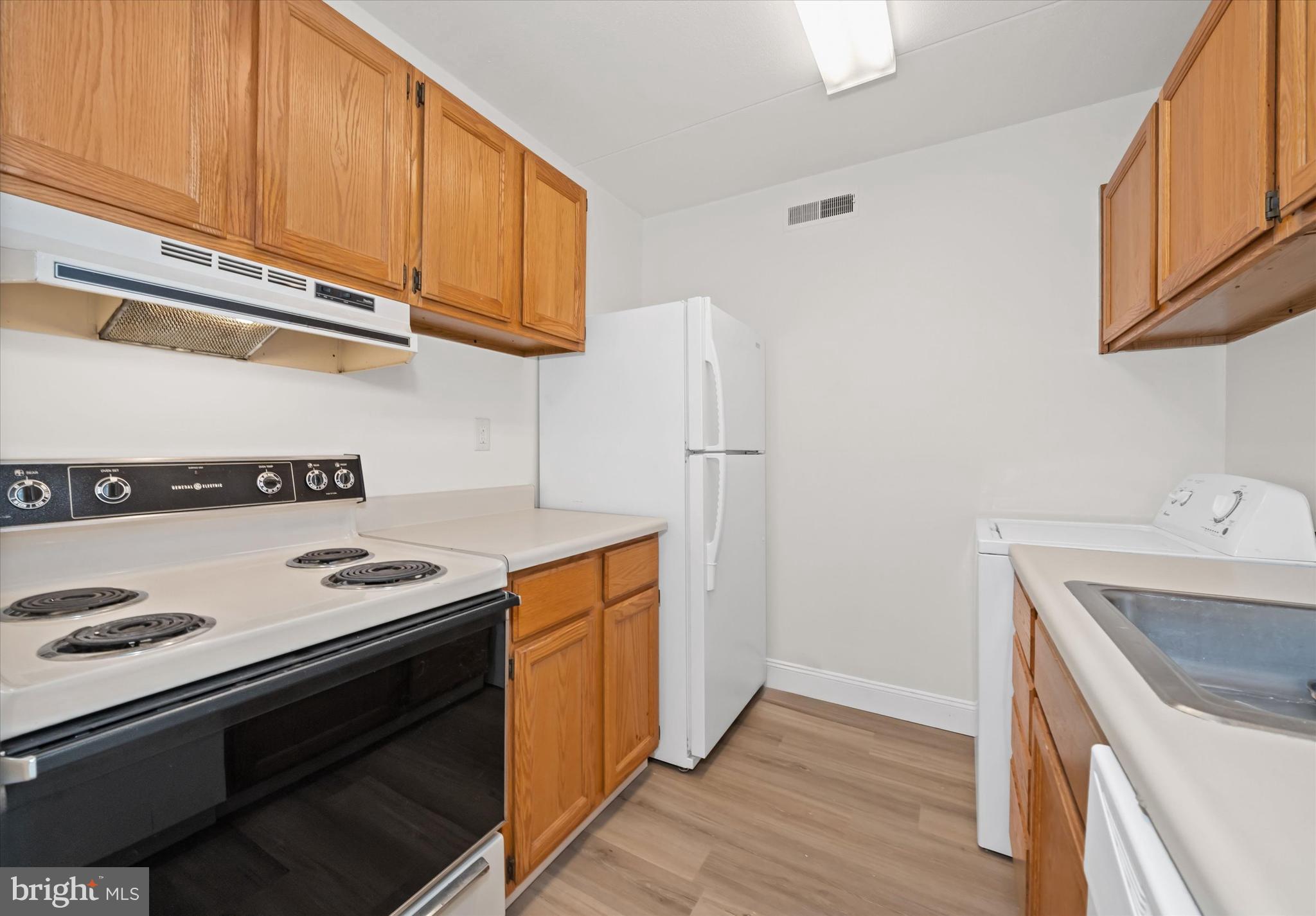 1 Berwyn Hall Dover, DE 19904 - Photo 12 of 16 a kitchen with stainless steel appliances granite countertop a sink stove and refrigerator