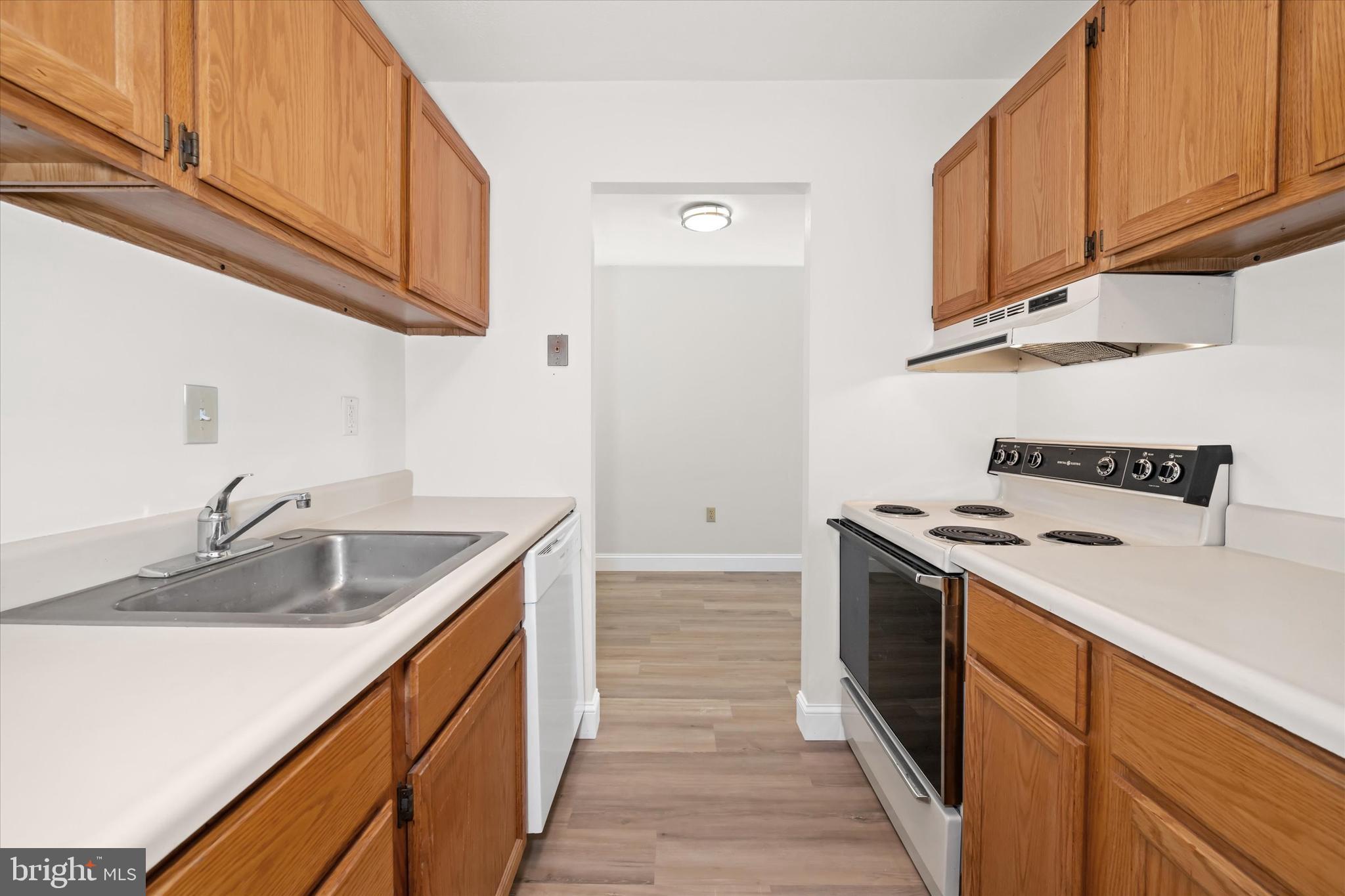 1 Berwyn Hall Dover, DE 19904 - Photo 13 of 16 a kitchen with granite countertop a sink stove and refrigerator