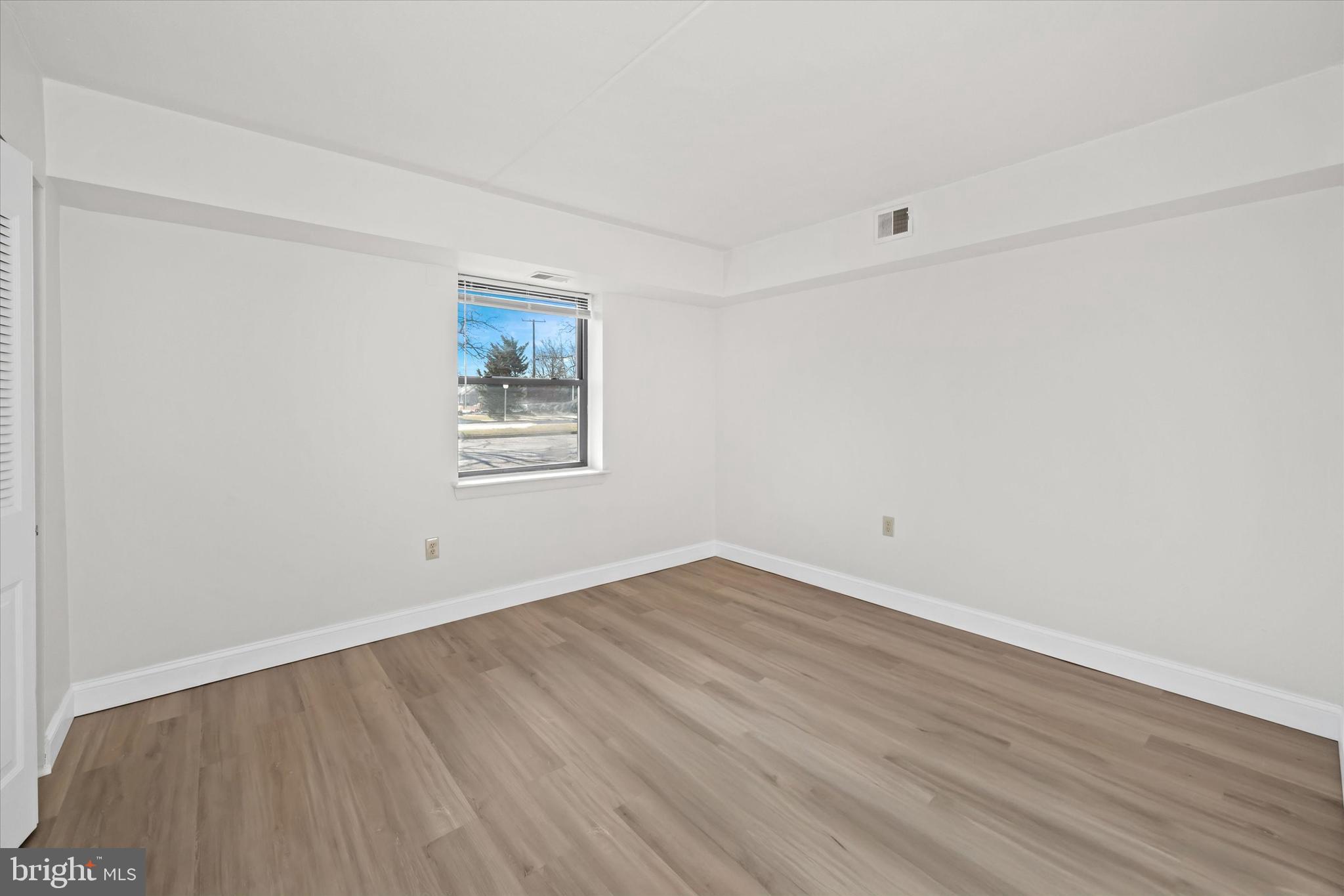 1 Berwyn Hall Dover, DE 19904 - Photo 14 of 16 an empty room with wooden floor and windows
