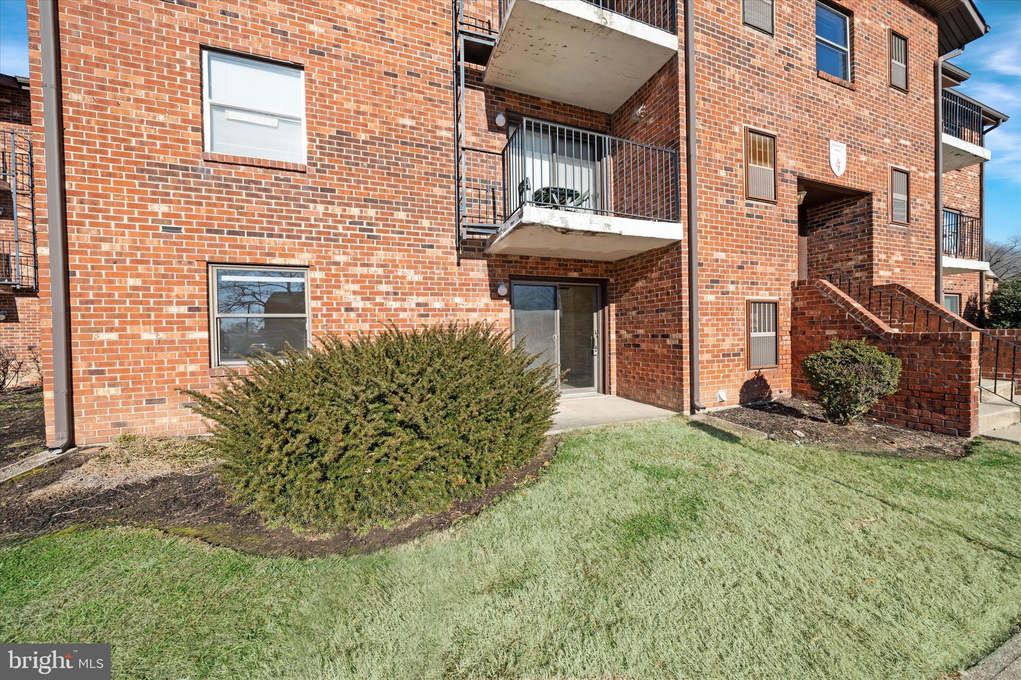 1 Berwyn Hall Dover, DE 19904 - Photo 2 of 16 a view of a house with brick walls and a yard with plants