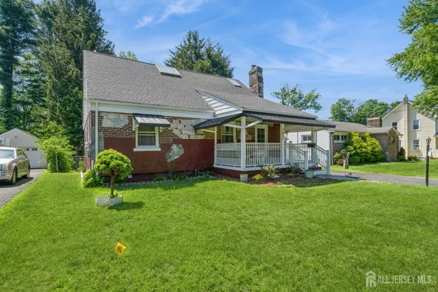 a view of a house with a backyard and a garden