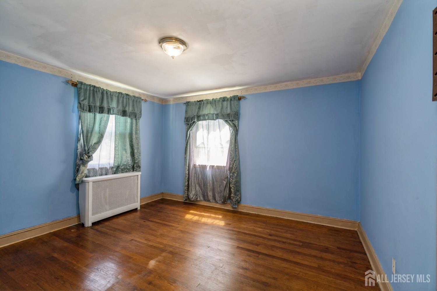 571 Greenbrook Road North Plainfield, NJ 07063 - Photo 15 of 28 an empty room with wooden floor and windows