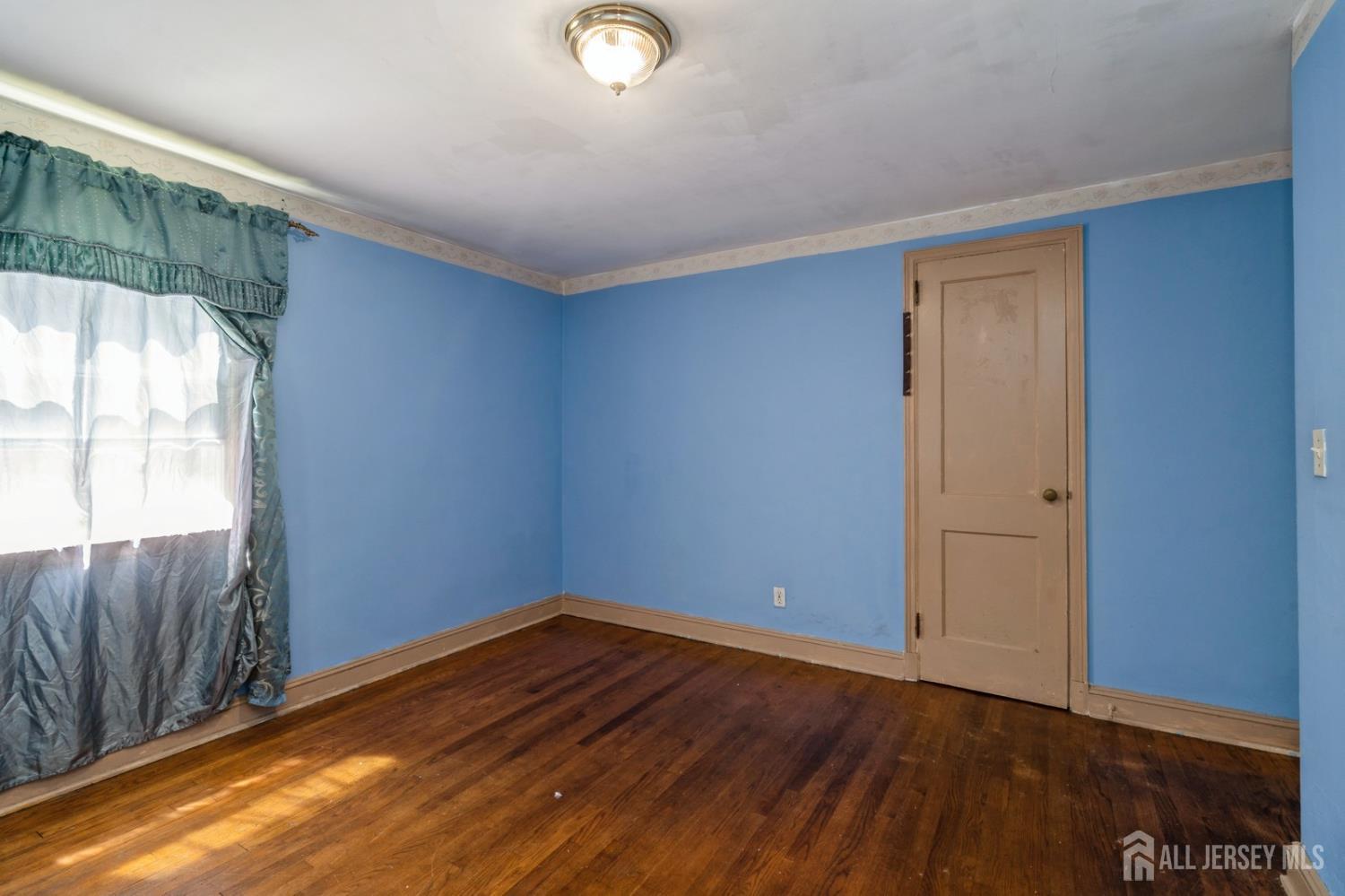 571 Greenbrook Road North Plainfield, NJ 07063 - Photo 16 of 28 an empty room with wooden floor and windows