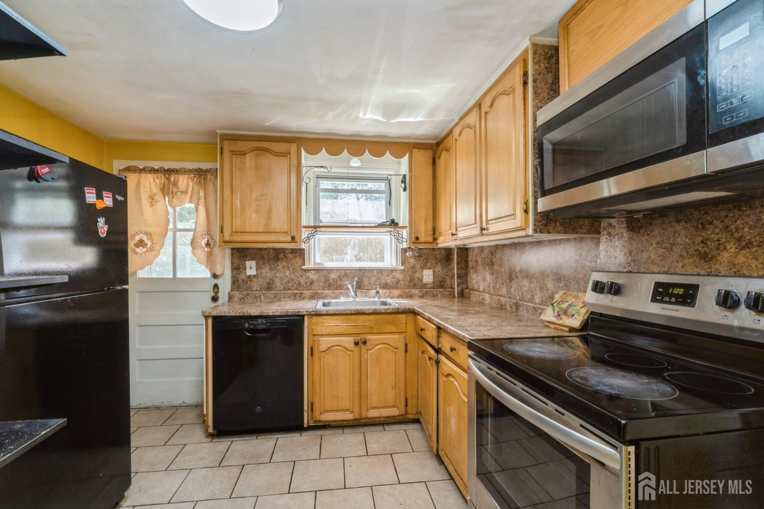 571 Greenbrook Road North Plainfield, NJ 07063 - Photo 18 of 28 a kitchen with a sink stove and microwave