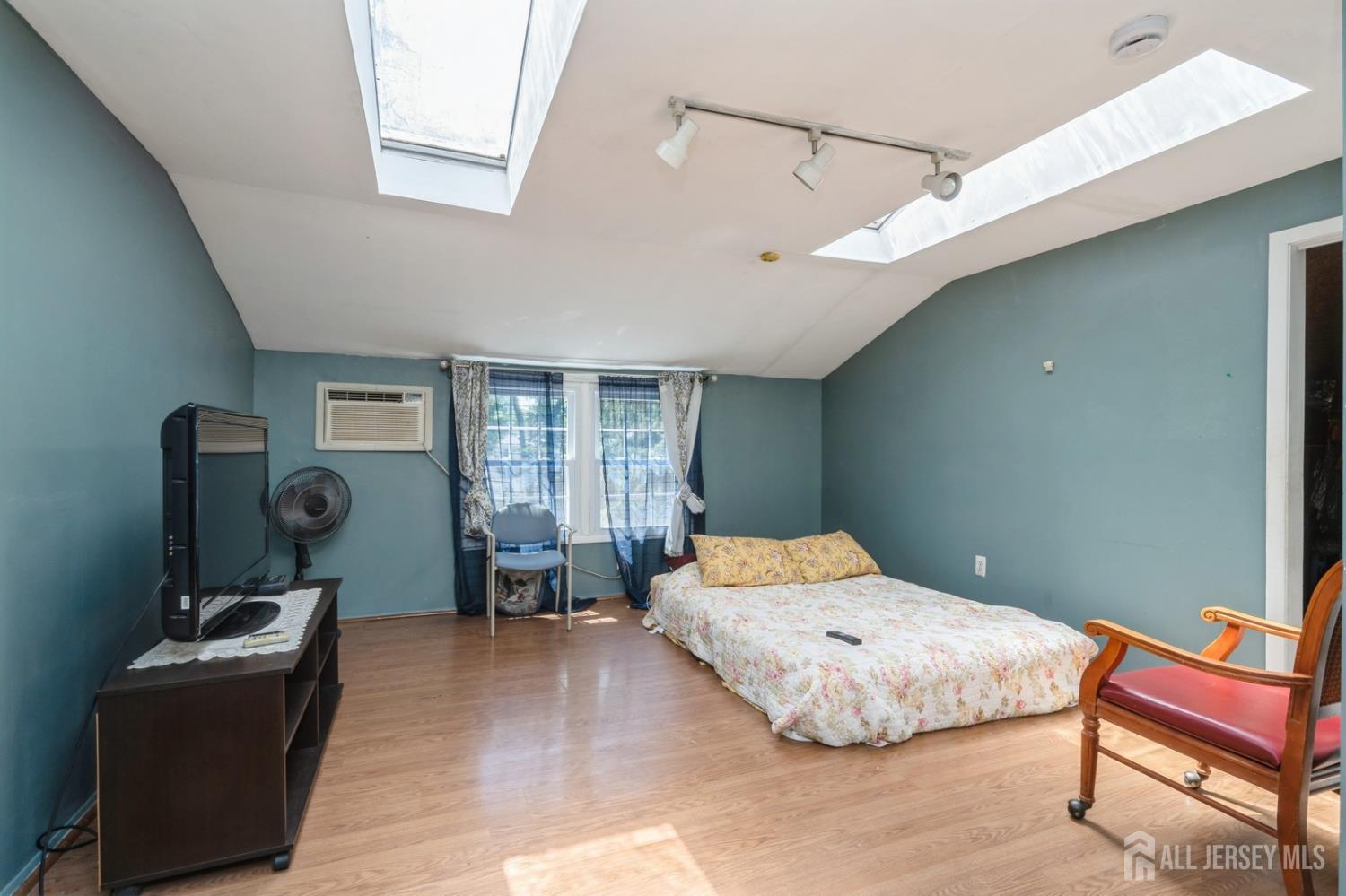 571 Greenbrook Road North Plainfield, NJ 07063 - Photo 20 of 28 a bedroom with a bed and wooden floor