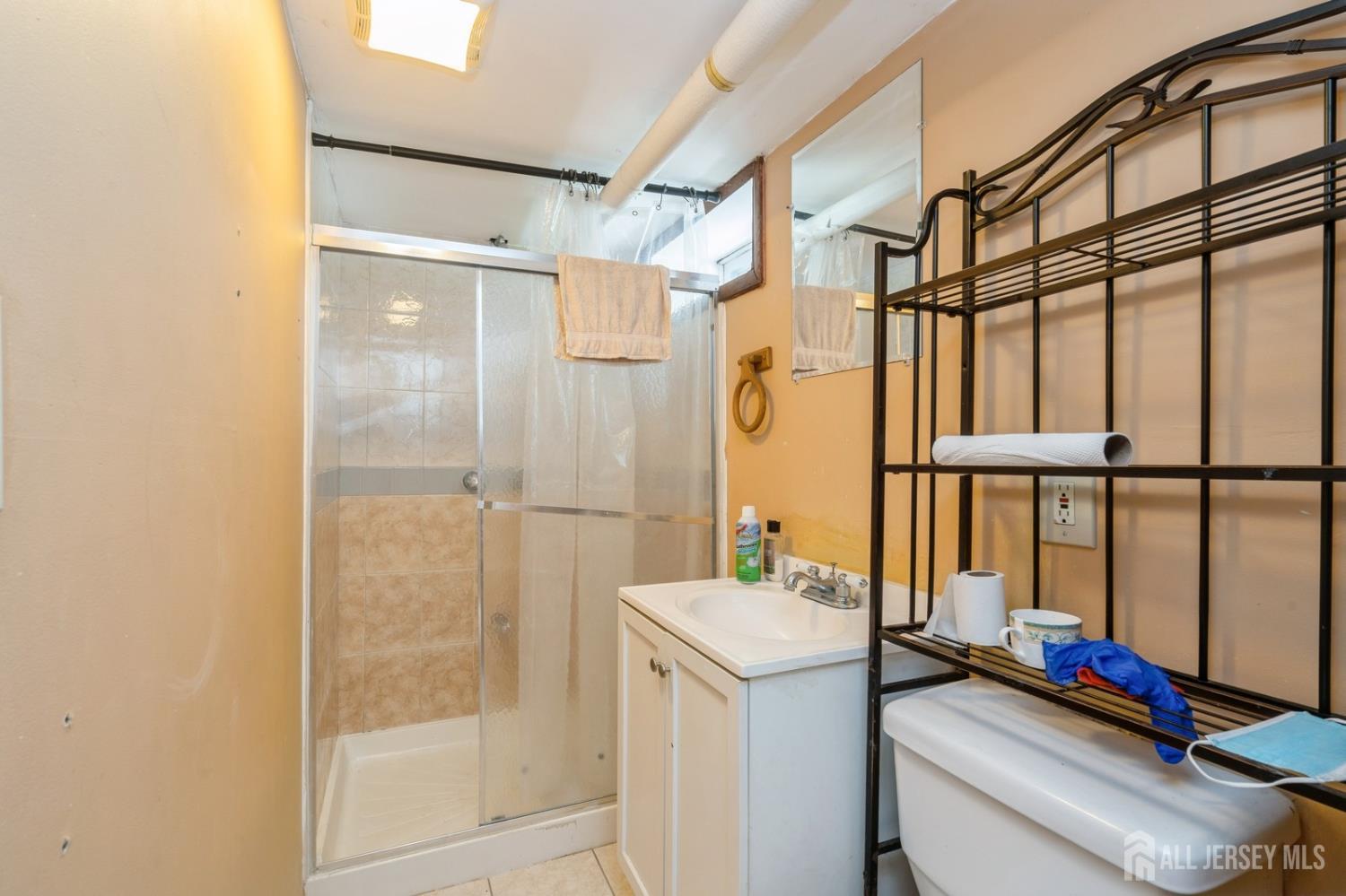 571 Greenbrook Road North Plainfield, NJ 07063 - Photo 24 of 28 a bathroom with a sink and a mirror