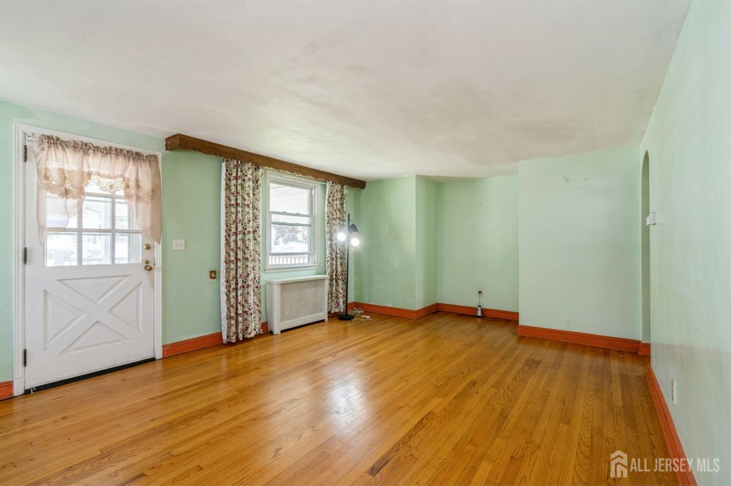 571 Greenbrook Road North Plainfield, NJ 07063 - Photo 8 of 28 a view of an empty room with wooden floor and a window