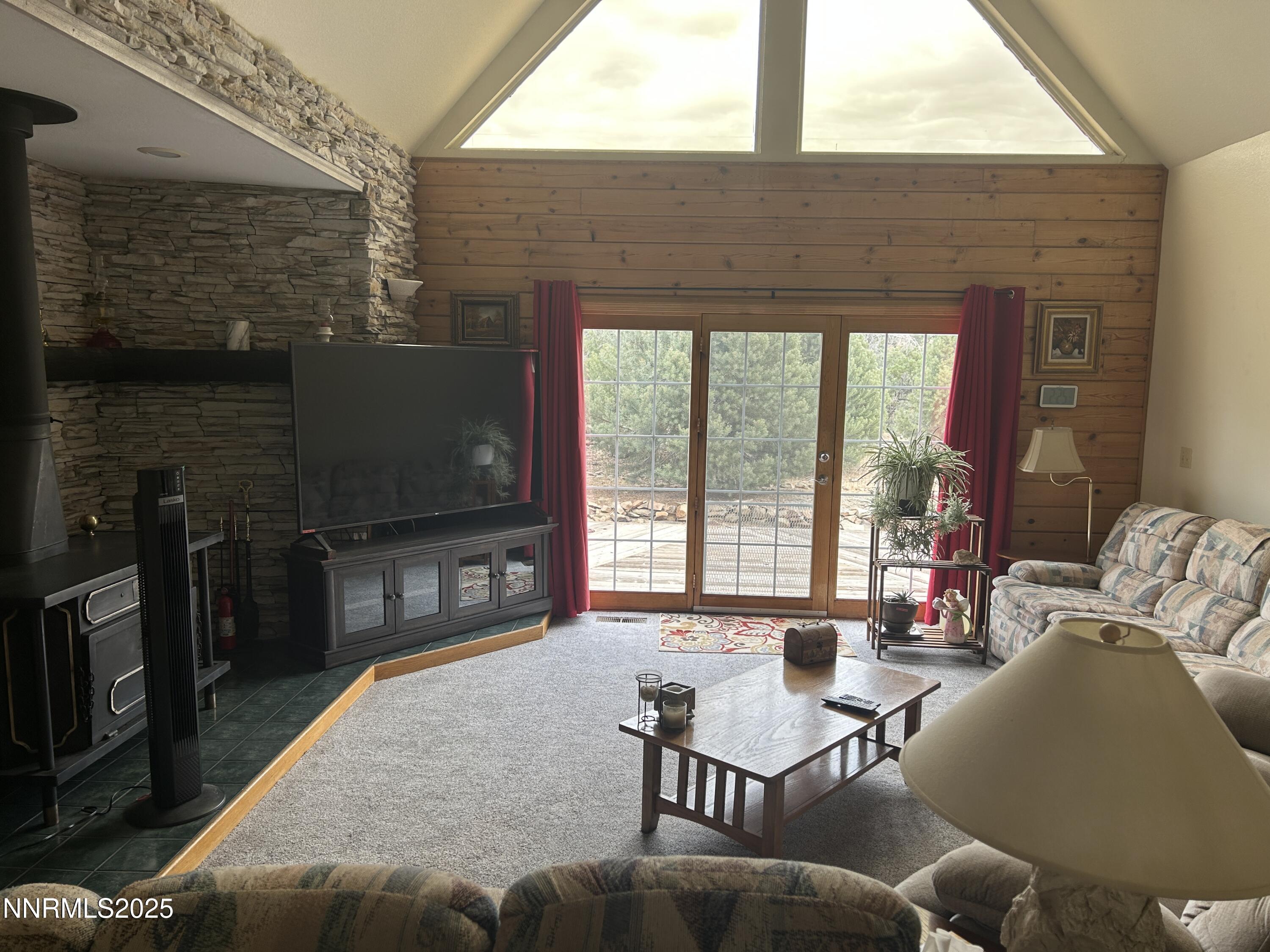 370 Panamint Road Reno, NV 89521 - Photo 6 of 8 a living room with furniture a flat screen tv and a fireplace