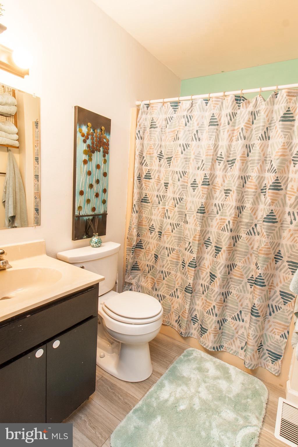 881 Sycamore Hill Road Severn, MD 21144 - Photo 14 of 18 a bathroom with a sink toilet and shower