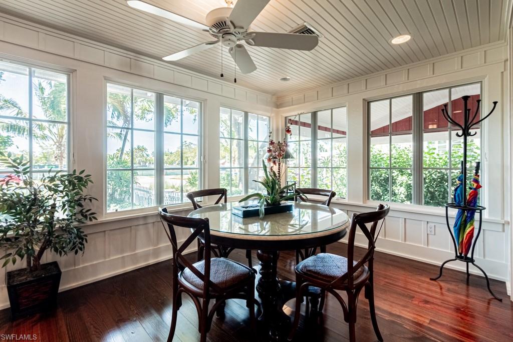 245 Broad Avenue South Naples, FL 34102 - Photo 13 of 50 a view of a dining room with furniture window and wooden floor
