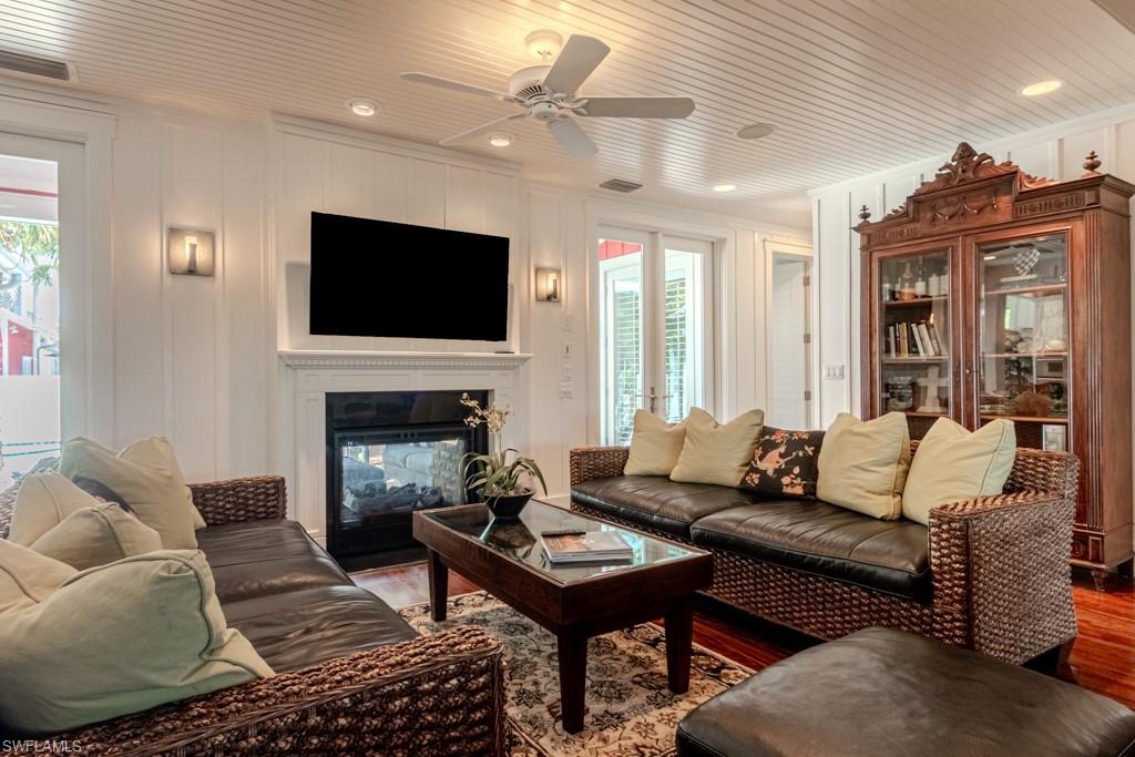 245 Broad Avenue South Naples, FL 34102 - Photo 20 of 50 a living room with furniture a flat screen tv and a fireplace