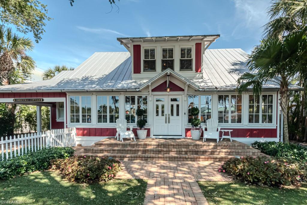 245 Broad Avenue South Naples, FL 34102 - Photo 2 of 50 front view of a house with a yard