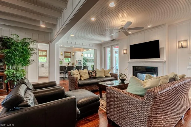 a living room with furniture a large window and a flat screen tv