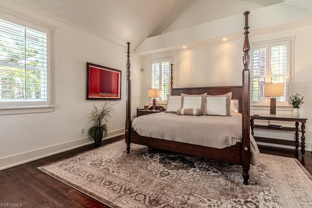 245 Broad Avenue South Naples, FL 34102 - Photo 28 of 50 a bedroom with a bed dresser and wooden floor