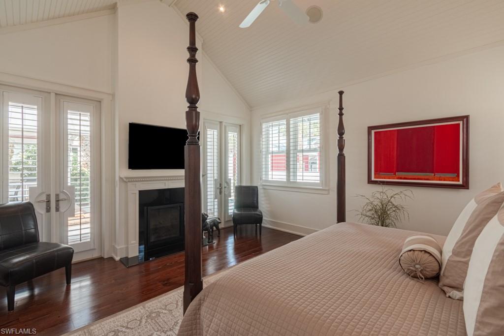 245 Broad Avenue South Naples, FL 34102 - Photo 29 of 50 a bedroom with a bed a window and a flat screen tv