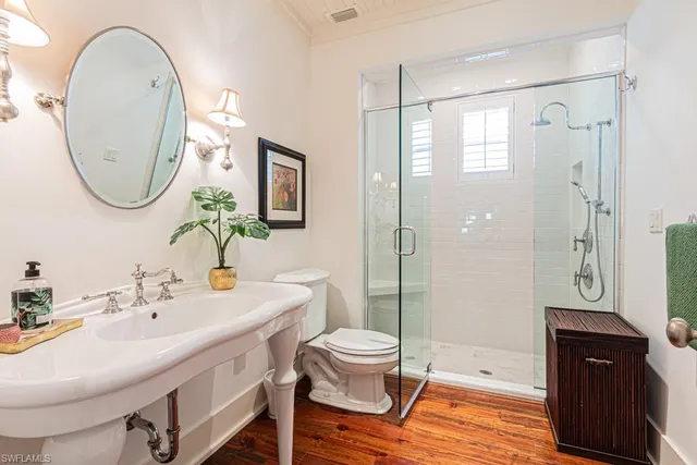a bathroom with a sink a toilet and a mirror