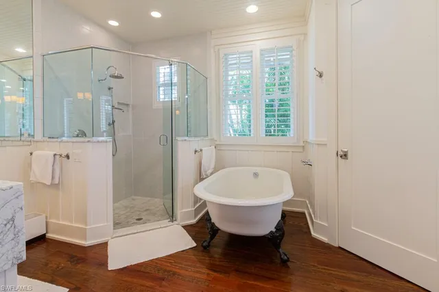 a spacious bathroom with a shower sink and mirror