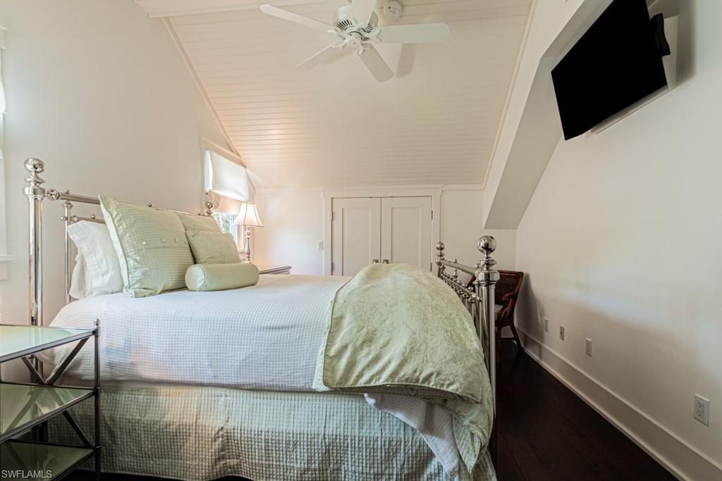 245 Broad Avenue South Naples, FL 34102 - Photo 38 of 50 a bedroom with a bed and a flat tv screen