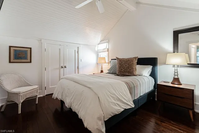 a bedroom with a bed and a chair