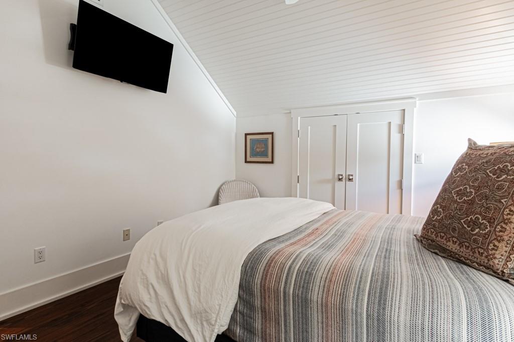 245 Broad Avenue South Naples, FL 34102 - Photo 41 of 50 a bedroom with a bed and a flat screen tv