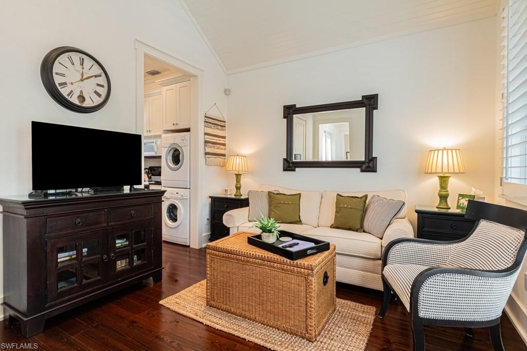 245 Broad Avenue South Naples, FL 34102 - Photo 45 of 50 a living room with furniture a flat screen tv and a fireplace