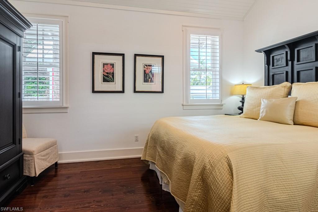 245 Broad Avenue South Naples, FL 34102 - Photo 47 of 50 a bedroom with a bed and wooden floor