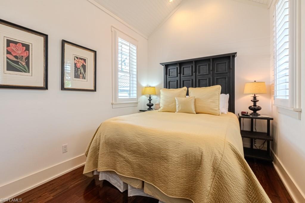 245 Broad Avenue South Naples, FL 34102 - Photo 48 of 50 a bedroom with a bed and wooden floor