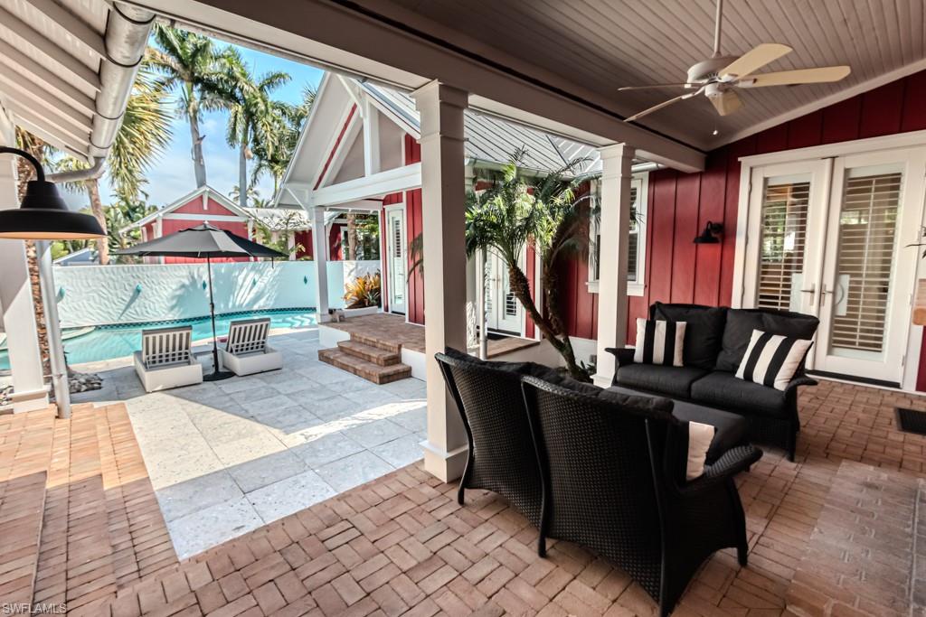 245 Broad Avenue South Naples, FL 34102 - Photo 7 of 50 a view of a patio with a dining table and chairs