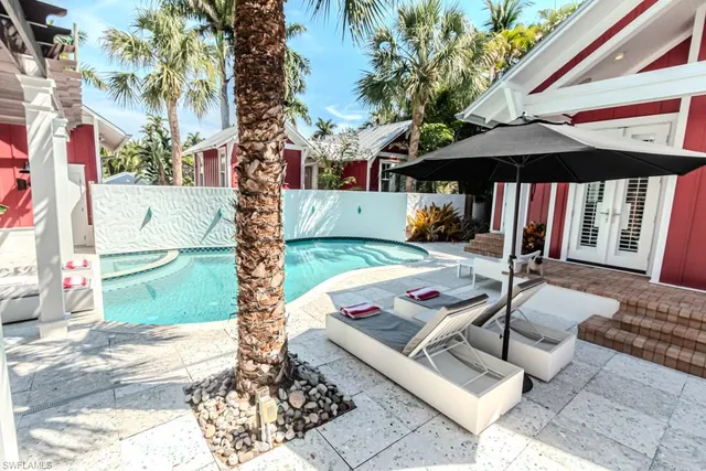 a view of a patio with a table and chairs under an umbrella