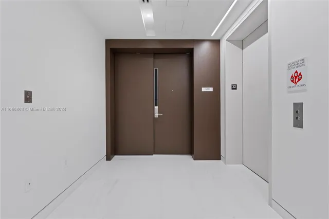 a living room with furniture and large windows