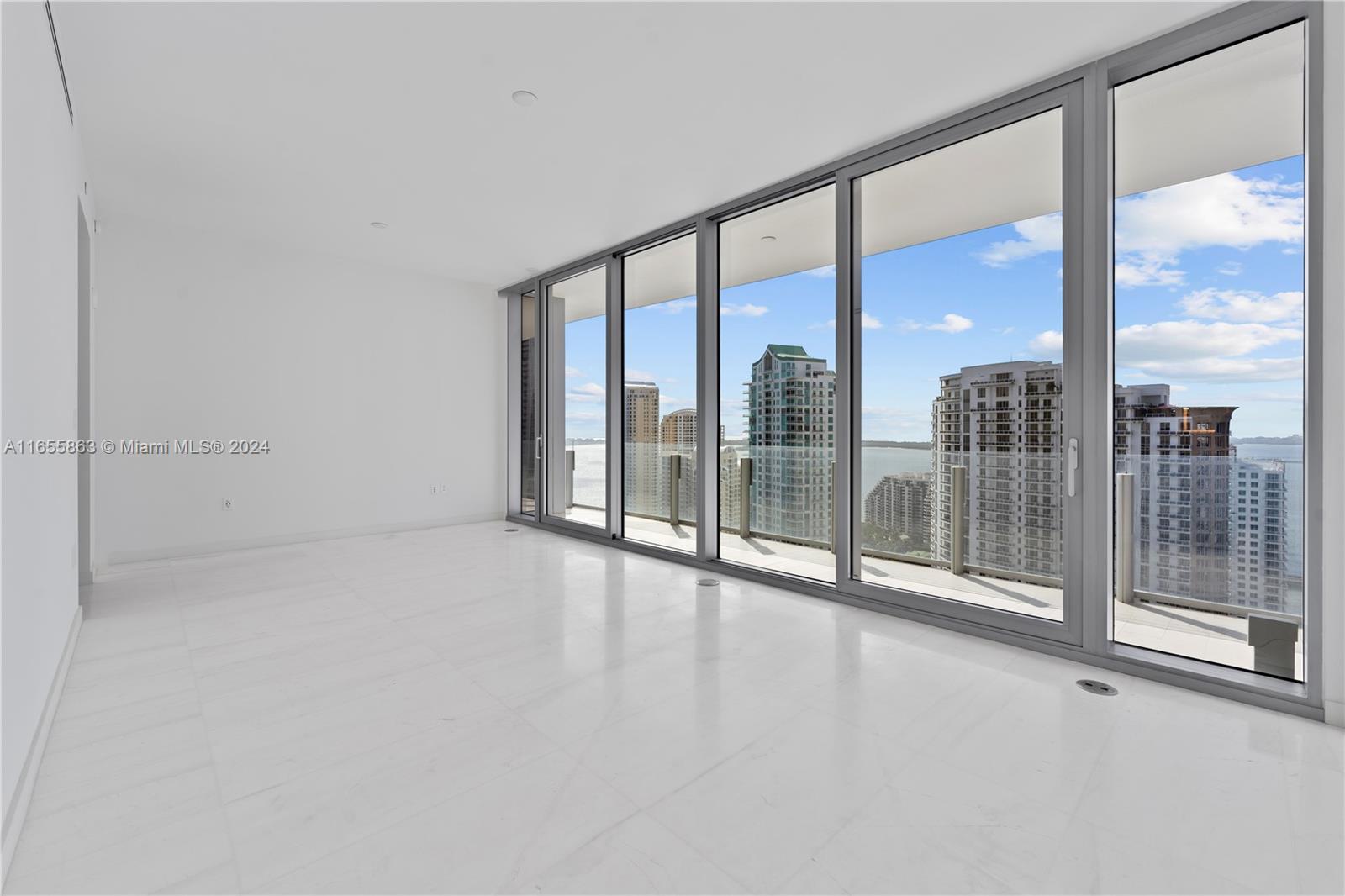 300 Biscayne Blvd Way, Unit 3201 Miami, FL 33131 - Photo 16 of 42 a view of an empty room with wooden floor and windows