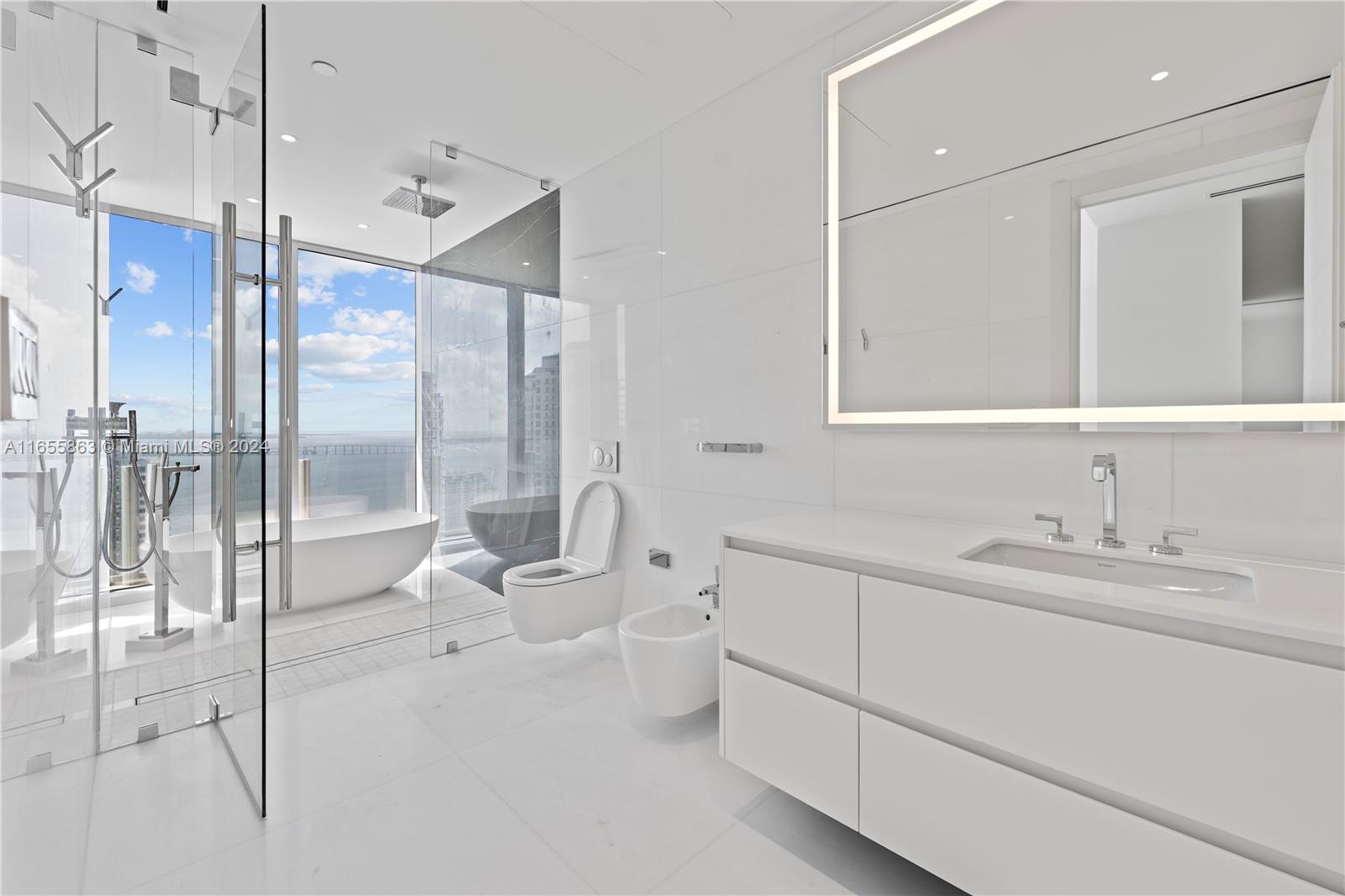 300 Biscayne Blvd Way, Unit 3201 Miami, FL 33131 - Photo 17 of 42 a bathroom with a double vanity sink toilet and shower