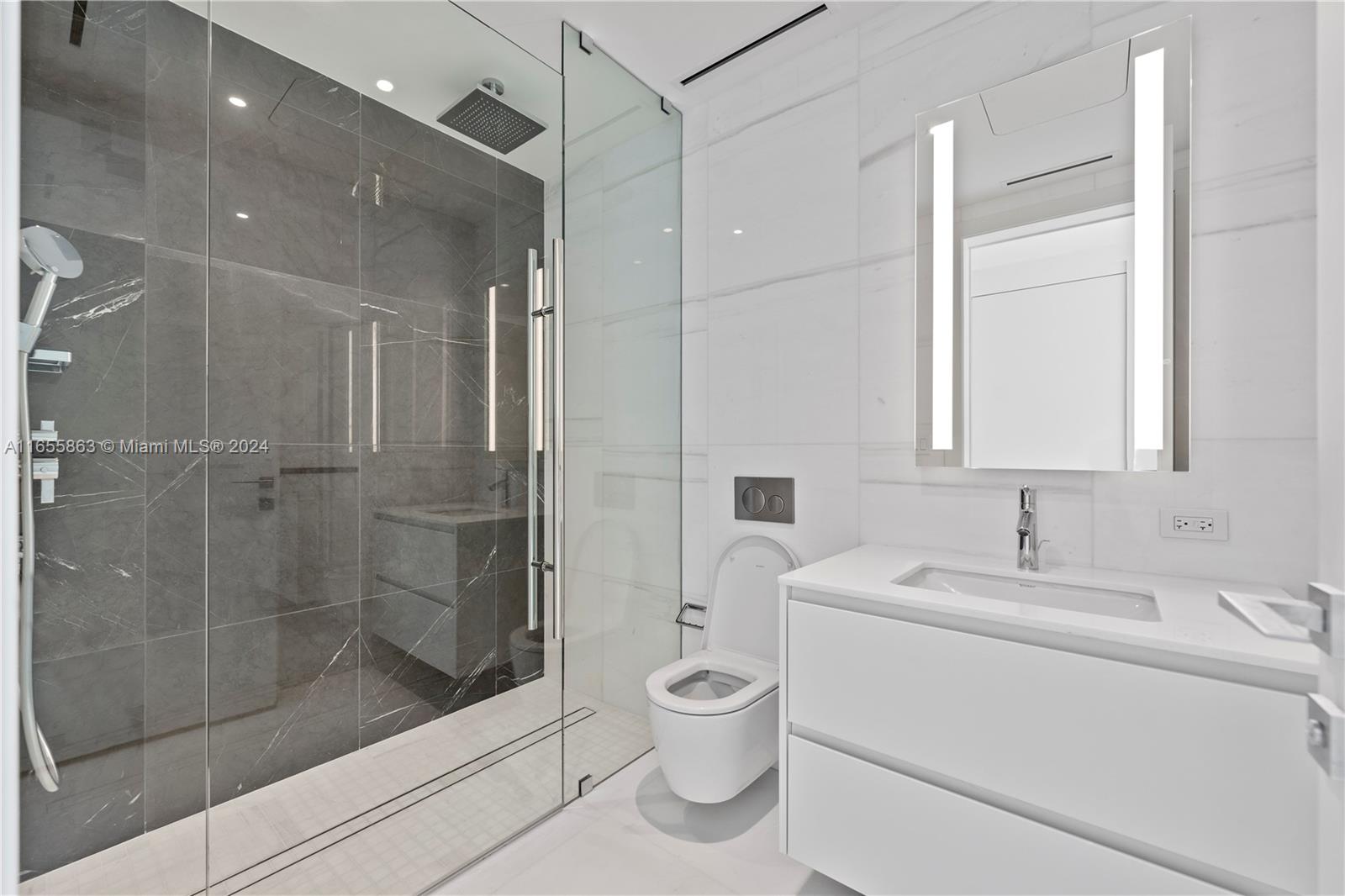 300 Biscayne Blvd Way, Unit 3201 Miami, FL 33131 - Photo 23 of 42 a bathroom with a toilet sink and shower