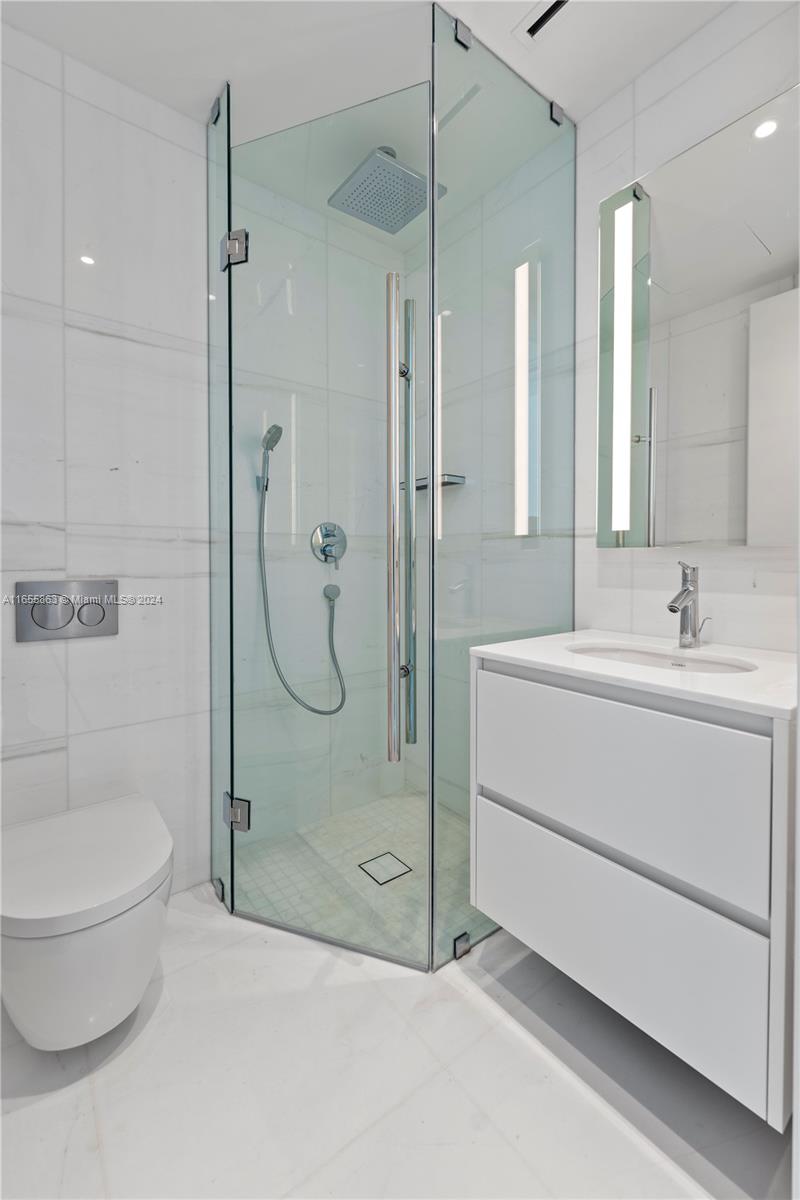 300 Biscayne Blvd Way, Unit 3201 Miami, FL 33131 - Photo 30 of 42 a bathroom with a shower a sink and toilet