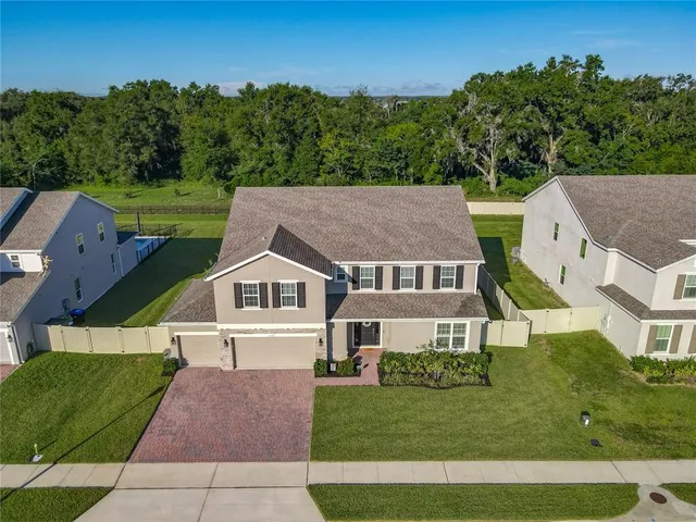 a aerial view of a house next to a yard