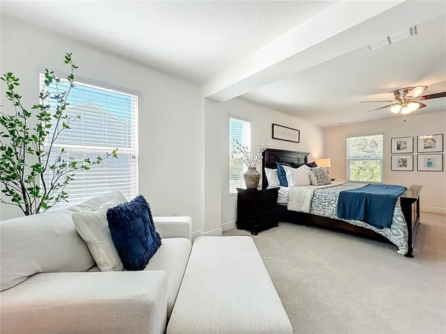 a bedroom with a bed couch and window