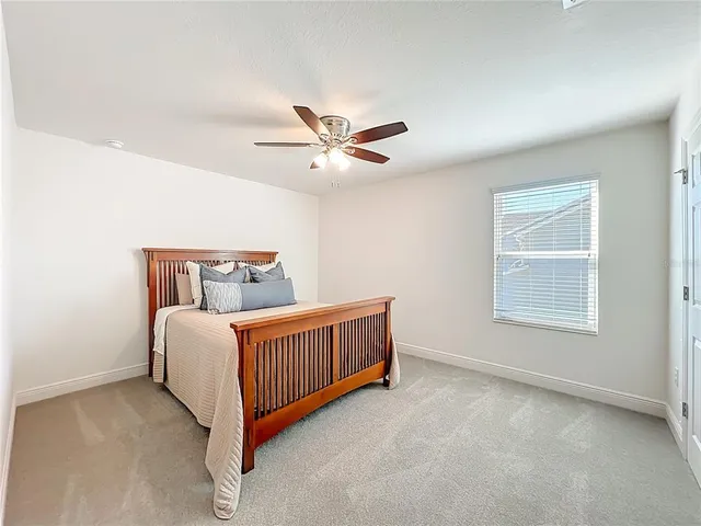 a bedroom with furniture and a large window