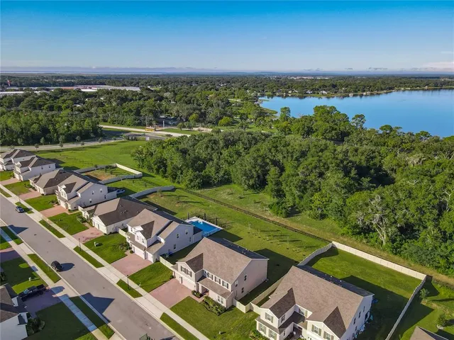 an aerial view of residential houses with outdoor space and swimming pool