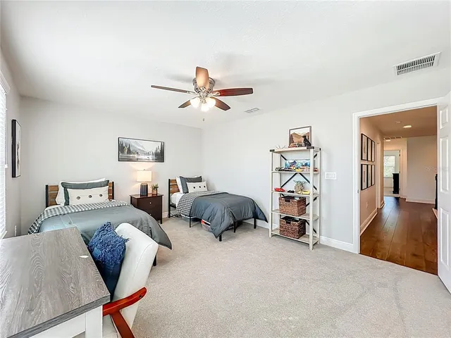 a large bathroom with a sink and a wooden floor