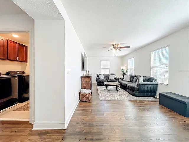 a spacious bedroom with a bed and a chandelier