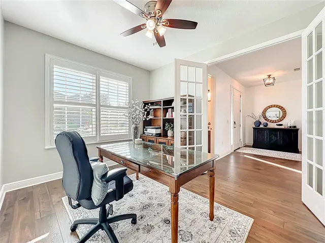 a view of a livingroom with furniture and a ceiling fan