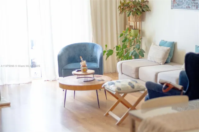 a living room with furniture and a potted plant