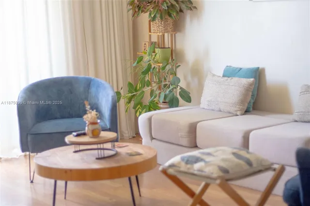 a living room with furniture and a potted plant