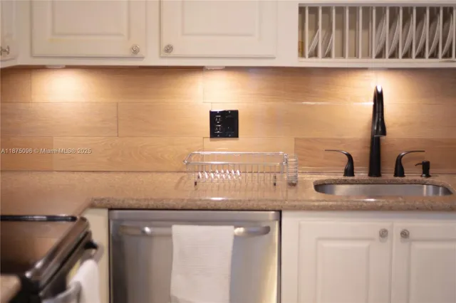 a kitchen with a sink and cabinets