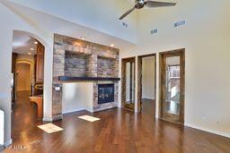 9265 East Canyon View Road Scottsdale, AZ 85255 - Photo 14 of 39 a view of a livingroom with wooden floor and a fireplace