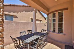 9265 East Canyon View Road Scottsdale, AZ 85255 - Photo 31 of 39 a view of a patio with table and chairs with barbeque grill and wooden floor