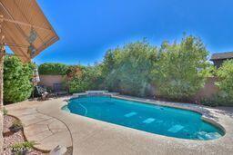 9265 East Canyon View Road Scottsdale, AZ 85255 - Photo 33 of 39 a view of a swimming pool with a yard