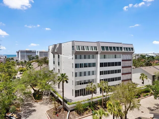 an aerial view of a house with outdoor space and lake view