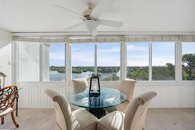 a view of a dining room with furniture large windows and wooden floor